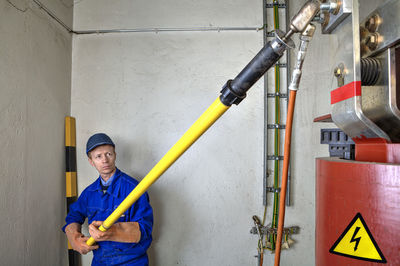 Portrait of man working against wall