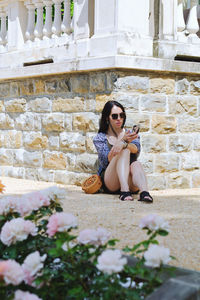 Young happy business woman relaxing in city, park. using phone. selfie. technology. summer vacation