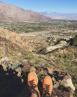 Low section of person standing on mountain