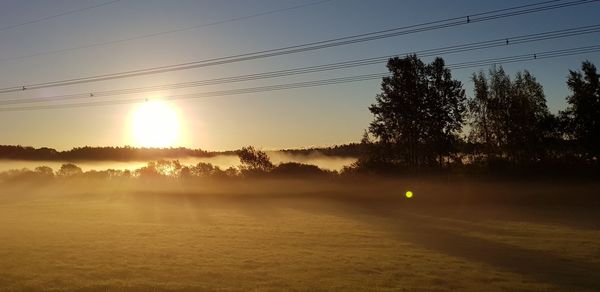 Scenic view of field against sky during sunset