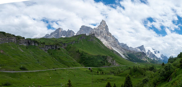 Scenic view of mountains against cloudy sky