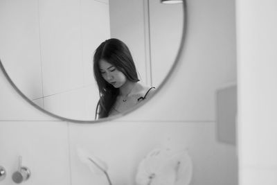 Reflection of young woman in mirror