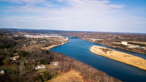 High angle view of river amidst city against sky
