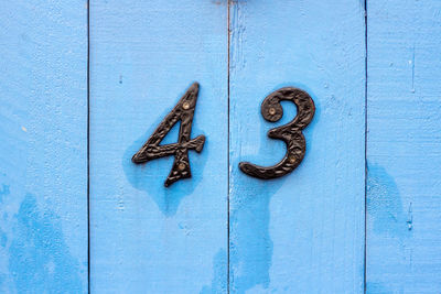 House number 43 on a blue wooden front door in london 