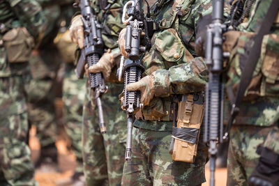 Soldiers with weapons on military combat training
