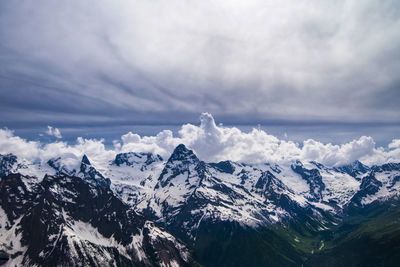 Scenic view of mountains against cloudy sky