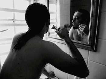 Close-up of man shaving