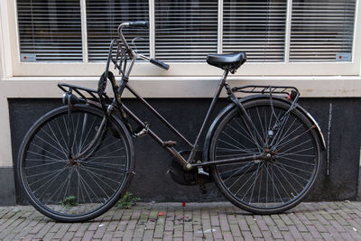 Bicycle parked on sidewalk by street