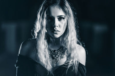 Portrait of young woman standing outdoors