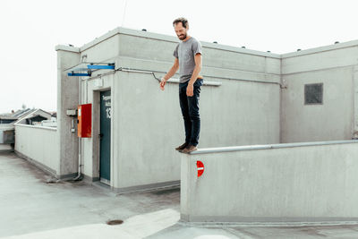 Smiling mid adult man standing on building terrace