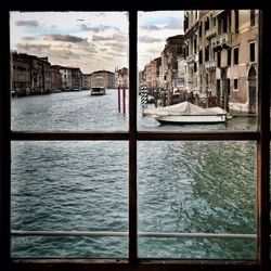 Boats in river with buildings in background