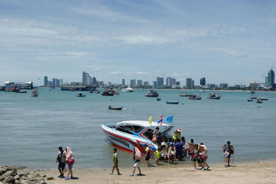 People disembarking from boat moored at shore