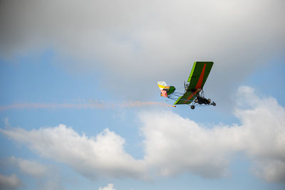 Low angle view of airplane flying against sky