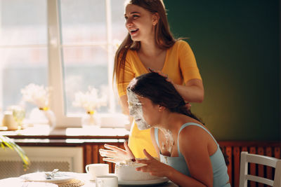 Young woman sitting on table