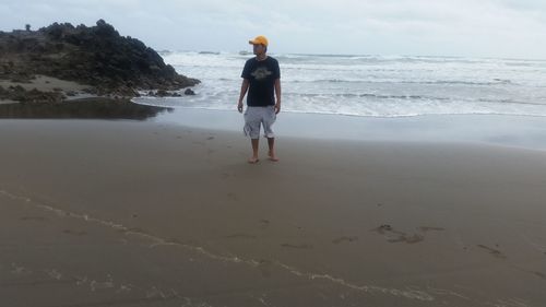 Rear view of woman standing on beach