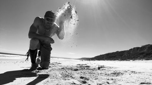 Full length of man on beach against sky