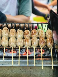 Isaan sausages being grilled on the stove