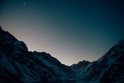 Moonrise over the snowy peaks in chile.