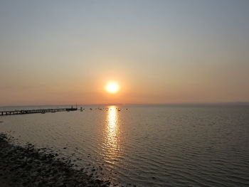 Scenic view of calm sea at sunset