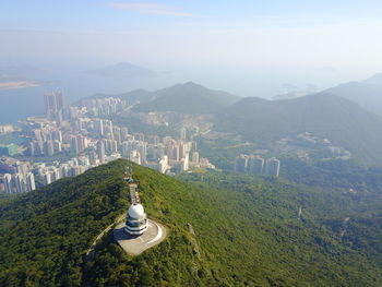 High angle view of cityscape and mountains in foggy weather