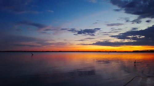 Scenic view of calm lake at sunset