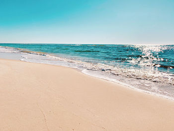 Scenic view of beach against clear sky