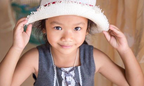 Portrait of cute girl wearing hat