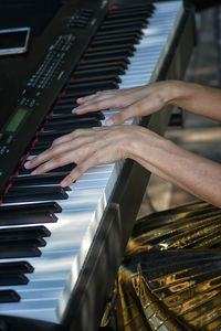 Midsection of woman playing piano