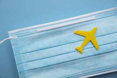 Close-up of yellow flag against blue background