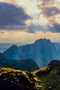 Portrait beautiful scenic mountain background with blue sky, cloud and blast horizon sun