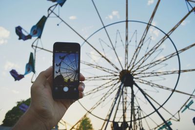 Low angle view of cropped person against sky