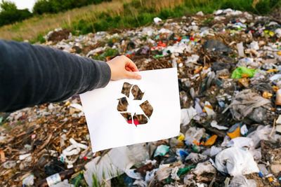 Cropped hand of woman holding paper