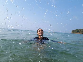 Smiling man swimming in sea