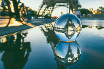 Close-up of crystal ball with reflection in water