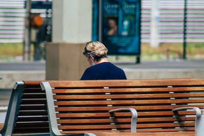 Rear view of man sitting on bench