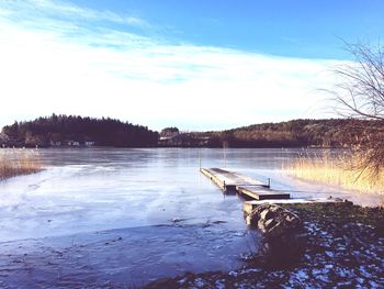 Scenic view of lake against sky during winter