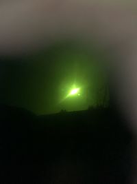 Low angle view of silhouette landscape against sky at night