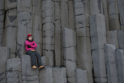 Woman sitting rock formation