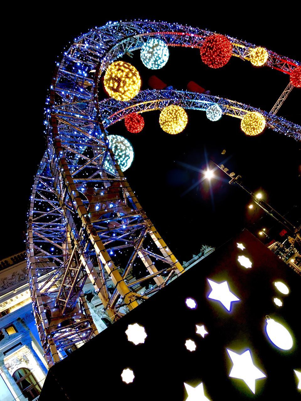 LOW ANGLE VIEW OF ILLUMINATED FERRIS WHEEL