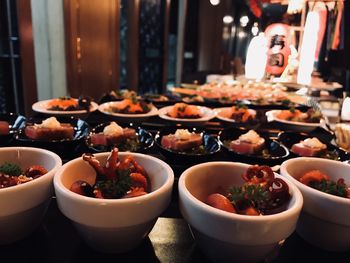 Seafood in bowls on table at restaurant