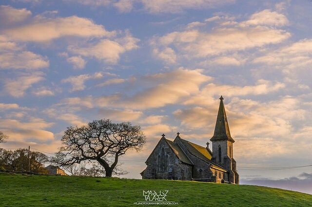 architecture, place of worship, building exterior, religion, built structure, church, spirituality, sky, cathedral, tree, cloud - sky, dome, grass, cross, famous place, travel destinations, history, cloud