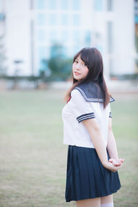 Woman in uniform standing on field