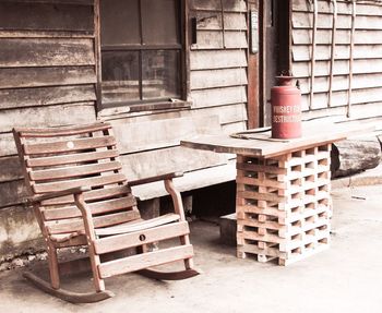 Empty chairs by abandoned building