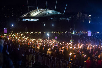 Crowd at music concert in city at night