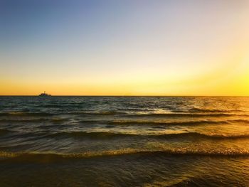 Scenic view of sea against clear sky during sunset