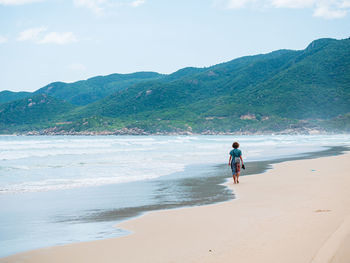 Full length of man on beach against sky