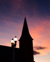 Low angle view of silhouette building against sky during sunset