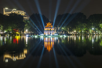 Reflection of illuminated buildings in lake at night