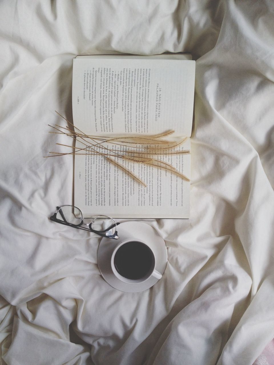 indoors, table, still life, coffee cup, book, coffee - drink, food and drink, high angle view, bed, drink, close-up, refreshment, paper, coffee, cup, home interior, healthcare and medicine, communication, napkin, education