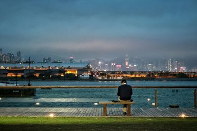 Man overlooking the river against the sky